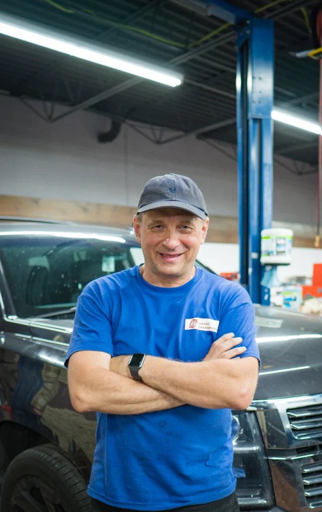 An AMPro team member in uniform inside the shop